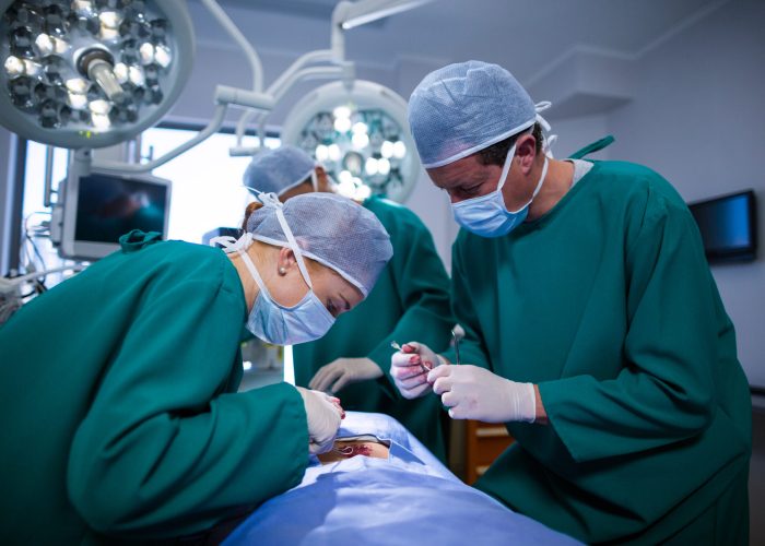 Surgeons performing operation in operation theater of hospital